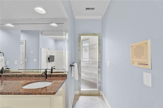 bathroom with vanity, ornamental molding, baseboards, and visible vents