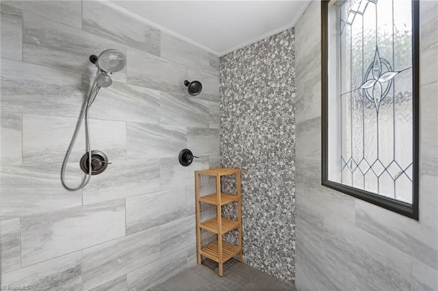 full bathroom with crown molding and tiled shower