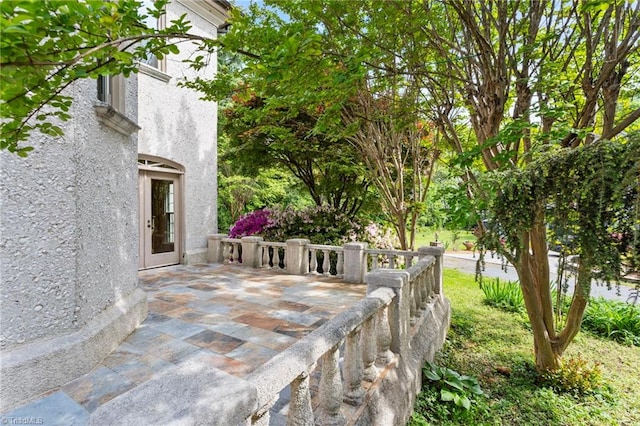 wooden terrace featuring a patio