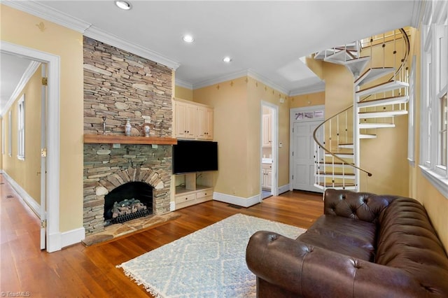 living area with recessed lighting, crown molding, wood finished floors, and stairs