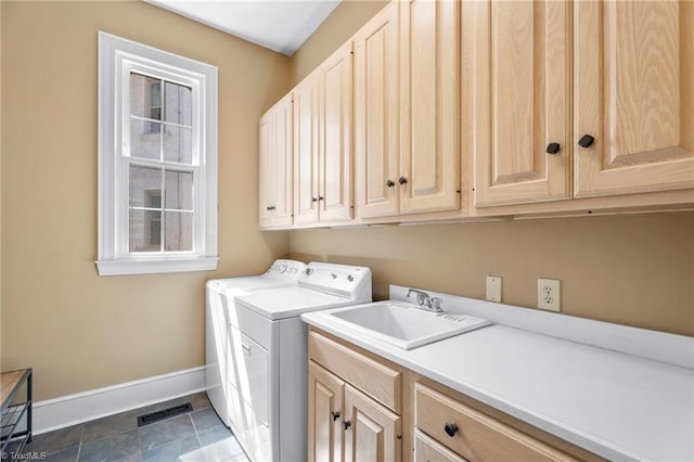 laundry area with baseboards, visible vents, a sink, separate washer and dryer, and cabinet space