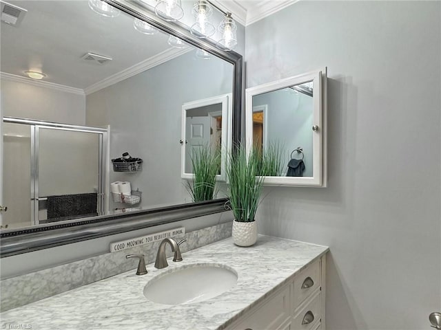 bathroom featuring crown molding, vanity, and visible vents