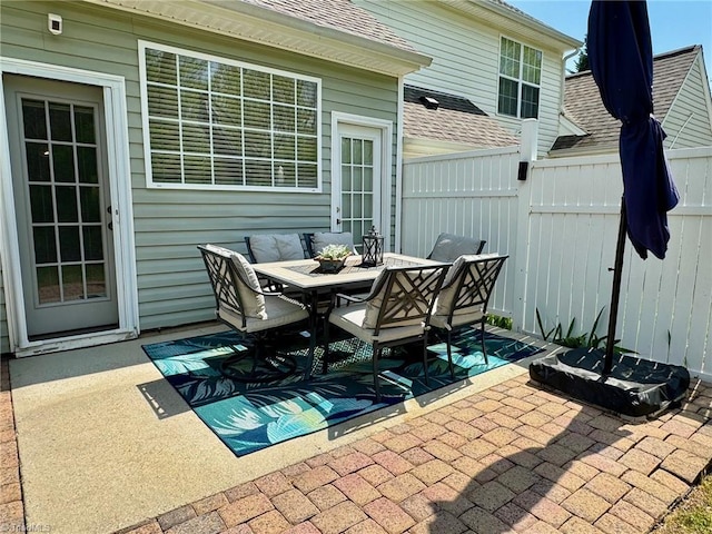 view of patio featuring outdoor dining space and fence