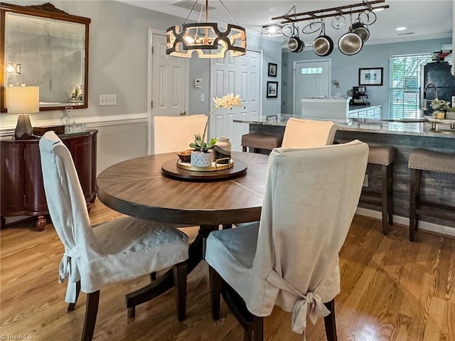 dining area with a chandelier and light wood-style floors