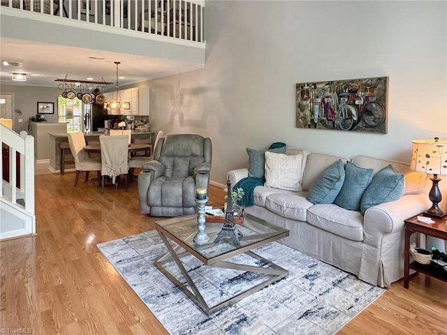 living area with visible vents and light wood-style floors