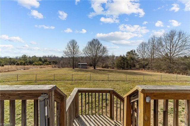 view of yard with a rural view and a wooden deck