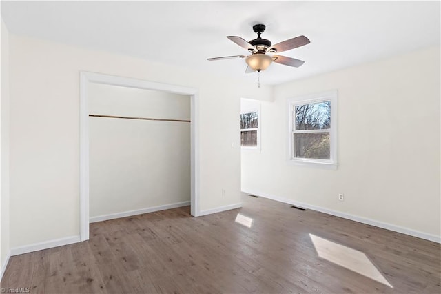 unfurnished bedroom featuring a closet, ceiling fan, and light wood-type flooring