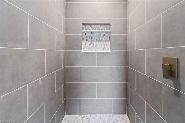 bathroom with tiled shower