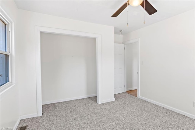 unfurnished bedroom featuring light carpet and ceiling fan