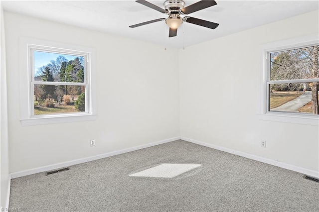 carpeted empty room featuring ceiling fan