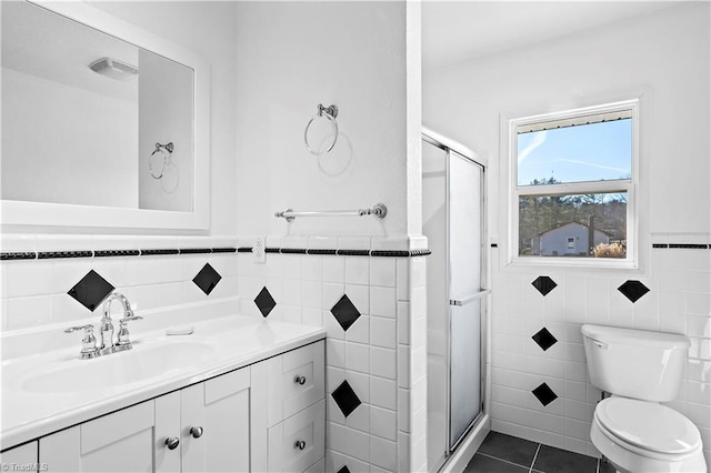 bathroom with vanity, tile patterned floors, toilet, and walk in shower