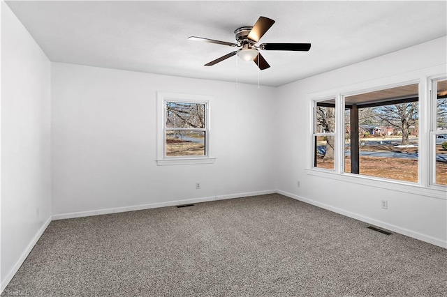 unfurnished room featuring ceiling fan and carpet