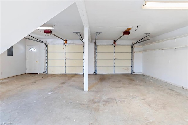 garage featuring a garage door opener and electric panel