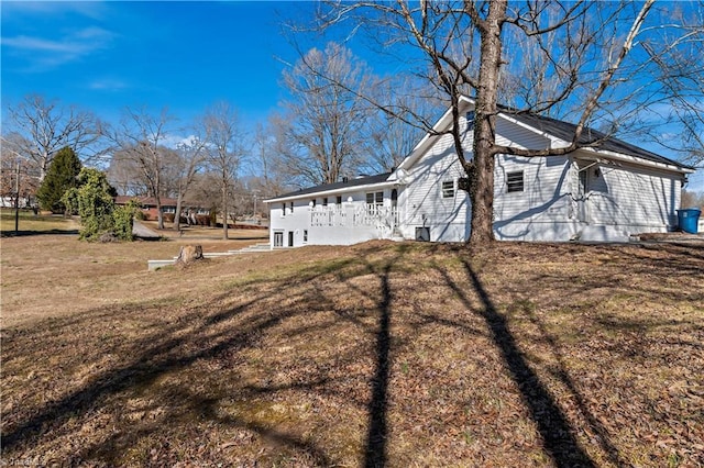 view of property exterior with a lawn