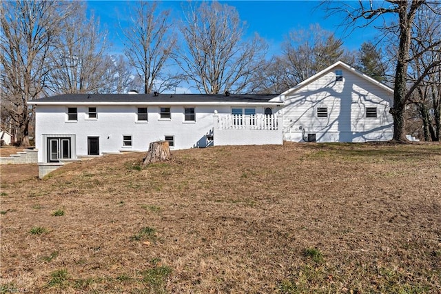 back of property with a lawn