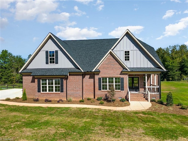 view of front facade featuring covered porch and a front lawn