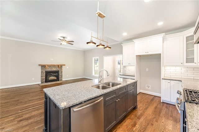 kitchen featuring sink, white cabinetry, tasteful backsplash, appliances with stainless steel finishes, and light stone countertops