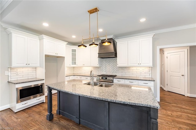 kitchen with white cabinetry, stainless steel appliances, sink, and light stone counters