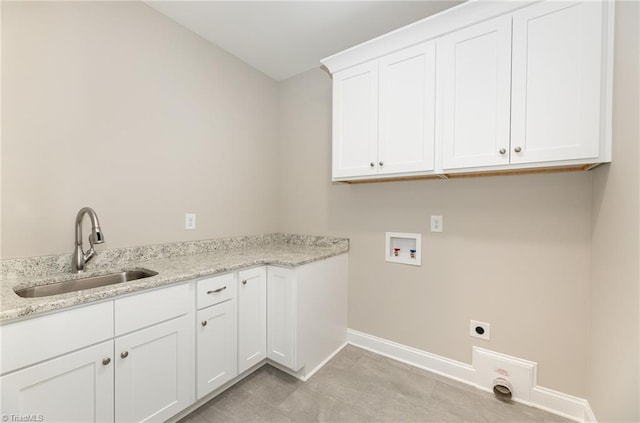 clothes washing area featuring hookup for a washing machine, sink, hookup for an electric dryer, and cabinets