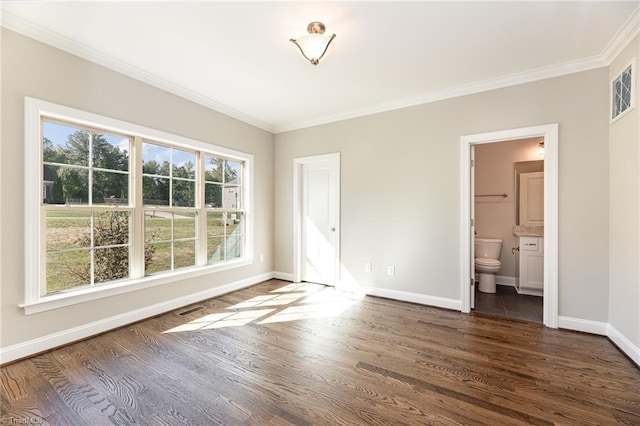 unfurnished bedroom featuring crown molding, ensuite bathroom, and dark hardwood / wood-style flooring