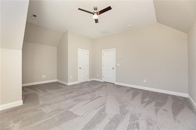 additional living space featuring vaulted ceiling, light colored carpet, and ceiling fan