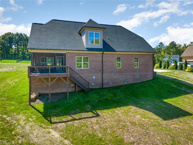 rear view of house with a wooden deck and a yard