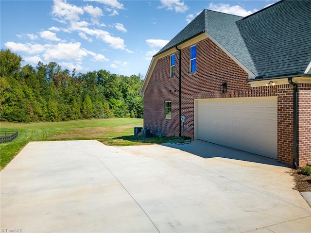 view of home's exterior with a garage and a yard