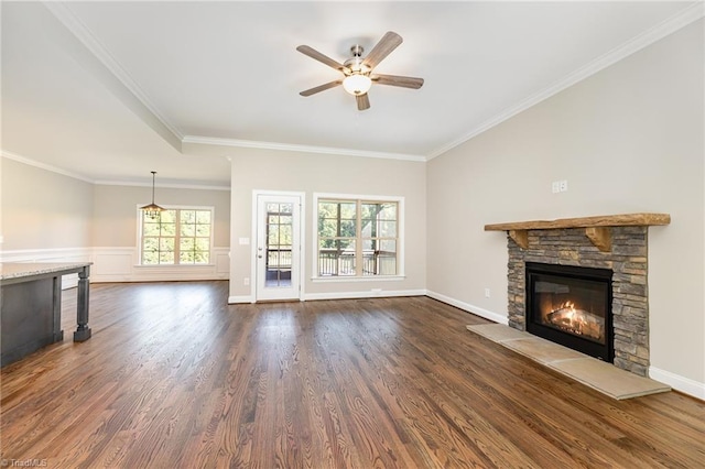 unfurnished living room featuring dark hardwood / wood-style flooring, crown molding, a fireplace, and ceiling fan