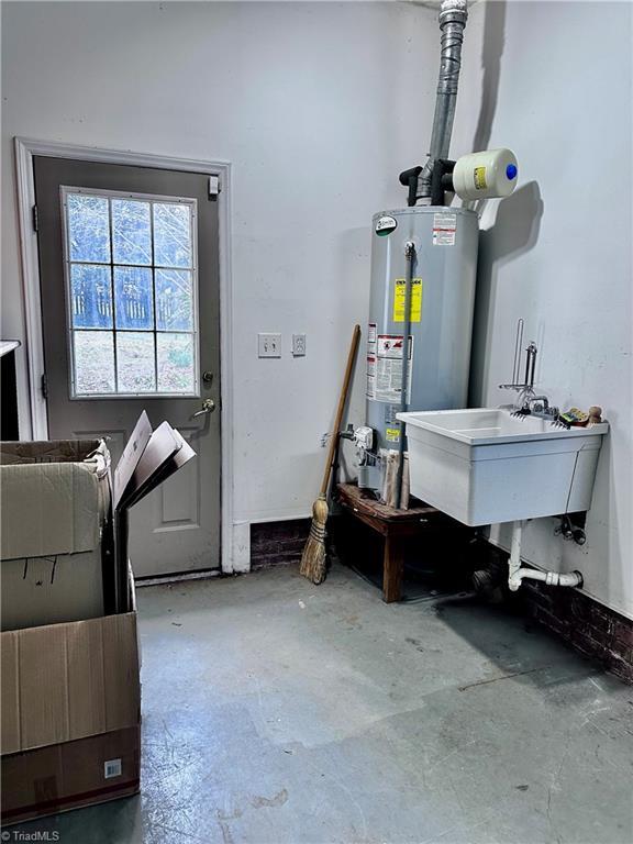 interior space featuring water heater and a sink