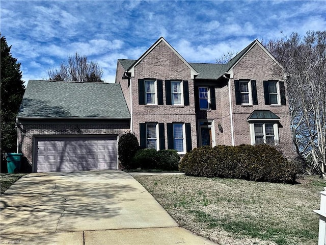 traditional home featuring concrete driveway, an attached garage, brick siding, and a shingled roof