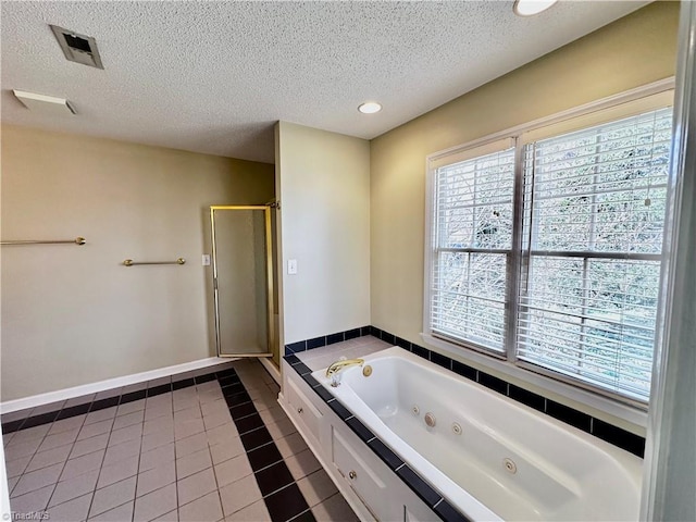 full bathroom with tile patterned floors, visible vents, a textured ceiling, a jetted tub, and a shower stall