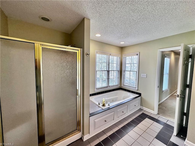 full bathroom with a stall shower, a textured ceiling, recessed lighting, tile patterned flooring, and a bath