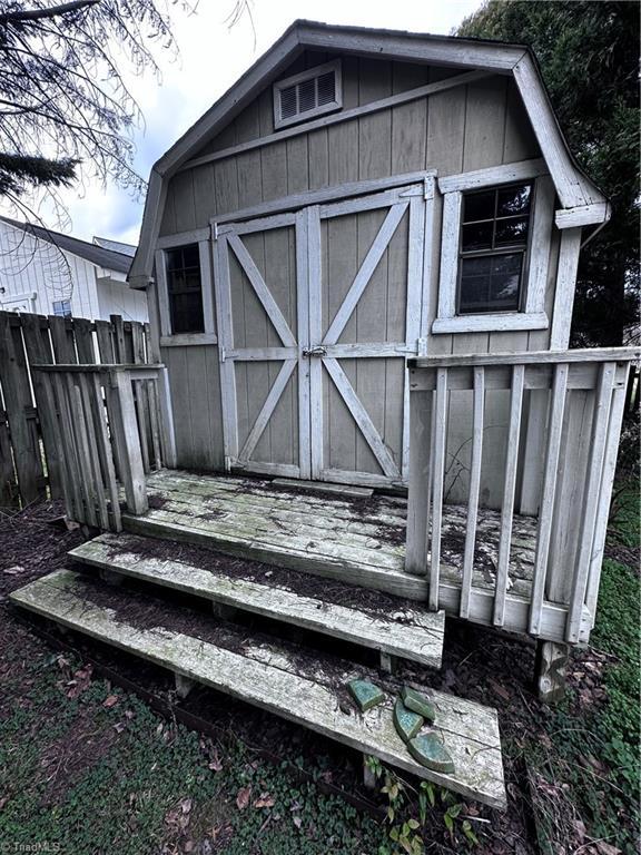 view of shed with fence