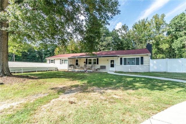 single story home with a front lawn and covered porch