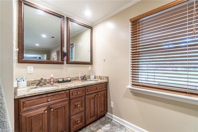 bathroom with ornamental molding and vanity