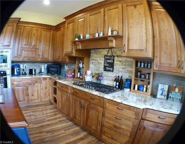 1564 Thore Rd, Pinnacle, NC 27043 - kitchen with appliances with stainless steel finishes, tasteful backsplash, brown cabinetry, and light stone counters