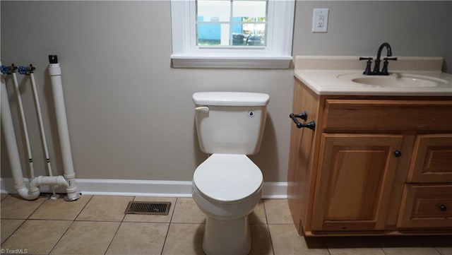 bathroom with tile patterned floors, vanity, and toilet