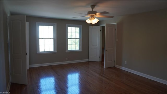 spare room featuring ceiling fan and dark hardwood / wood-style floors