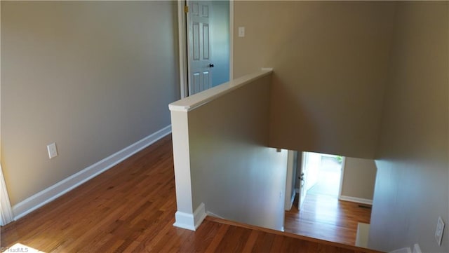 staircase featuring wood-type flooring