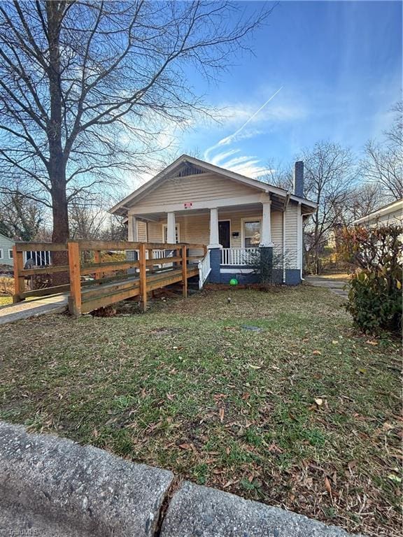 bungalow-style home with a porch and a front lawn