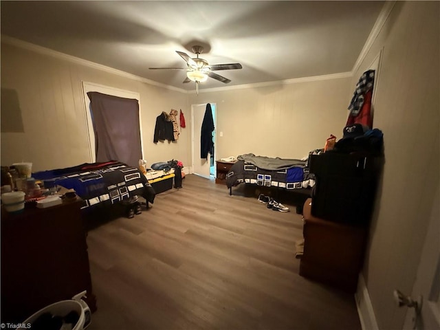 bedroom featuring hardwood / wood-style flooring, ornamental molding, and ceiling fan