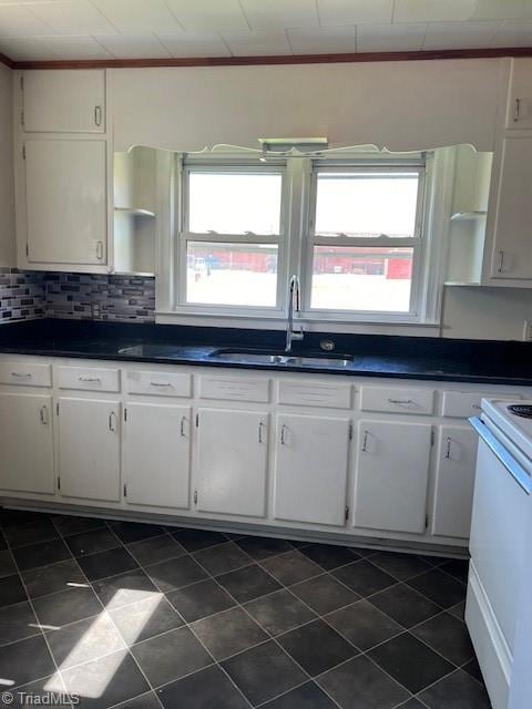 kitchen featuring backsplash, white cabinetry, sink, and white electric range oven