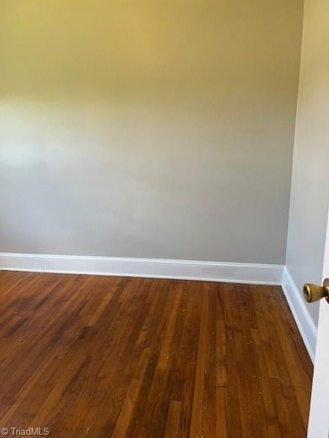 spare room featuring dark hardwood / wood-style flooring