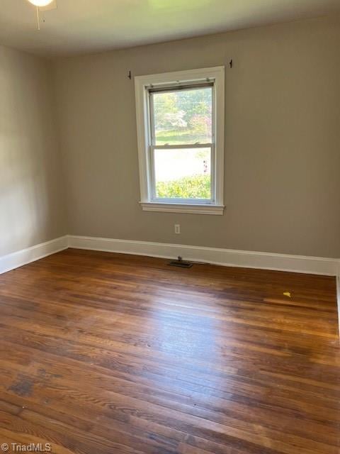 spare room featuring dark hardwood / wood-style flooring