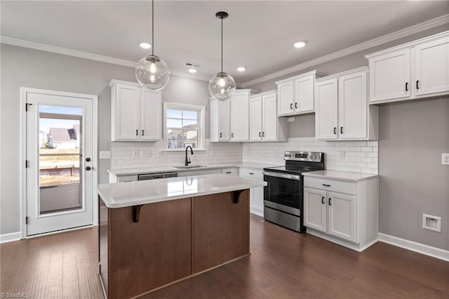 kitchen with stainless steel appliances, hanging light fixtures, a kitchen island, and white cabinets