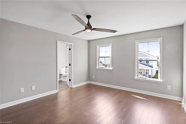 spare room featuring dark wood-type flooring and ceiling fan