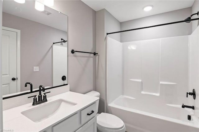 full bathroom featuring vanity, toilet, and  shower combination