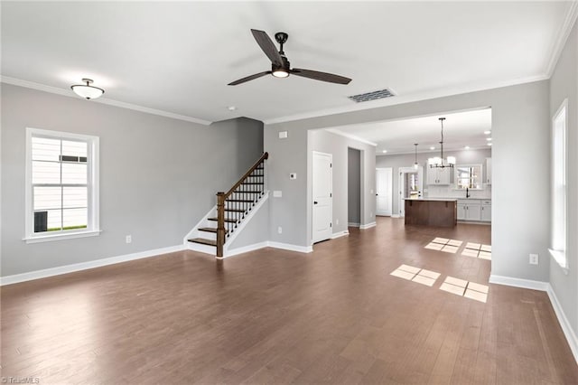 unfurnished living room featuring crown molding, dark hardwood / wood-style flooring, and ceiling fan with notable chandelier