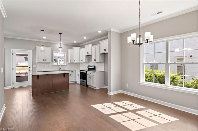 kitchen featuring stainless steel electric range, white cabinets, and a kitchen island