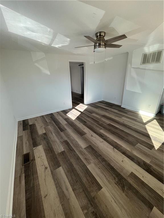 spare room with ceiling fan and dark wood-type flooring